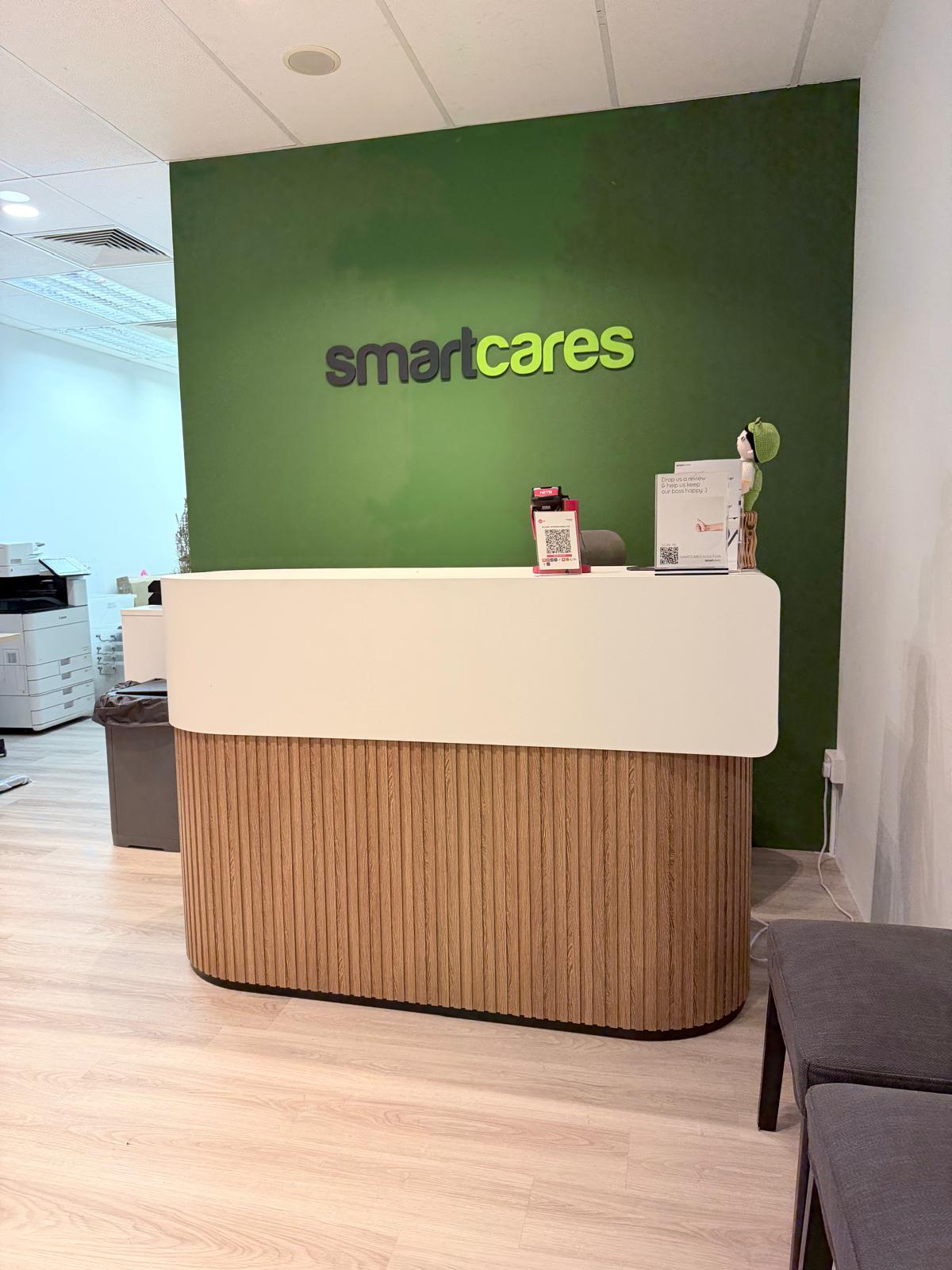 Custom curved reception counter featuring vertical wood fluted panelling and a white top.