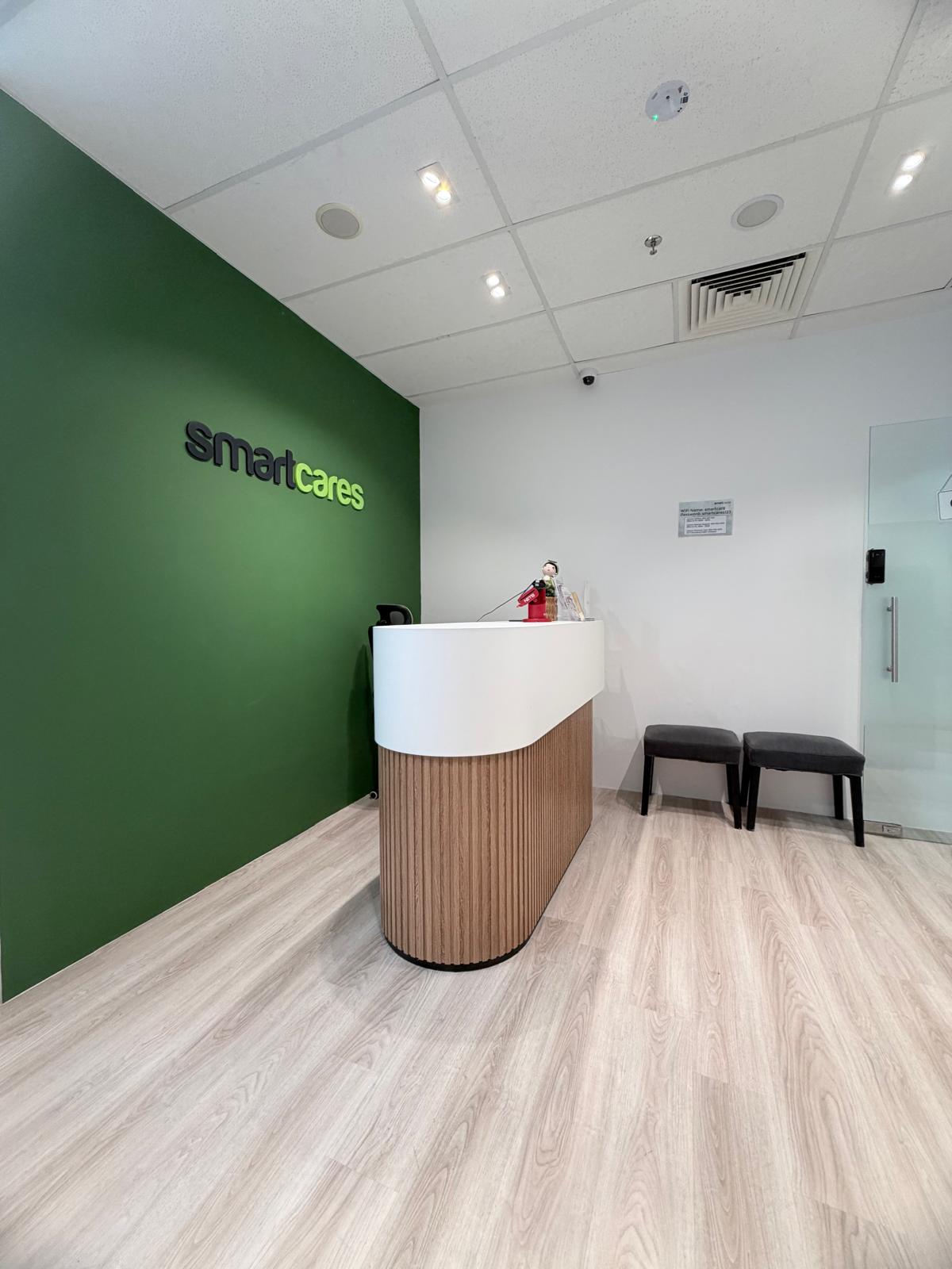 Recessed ceiling LED downlights illuminating a modern commercial reception room.