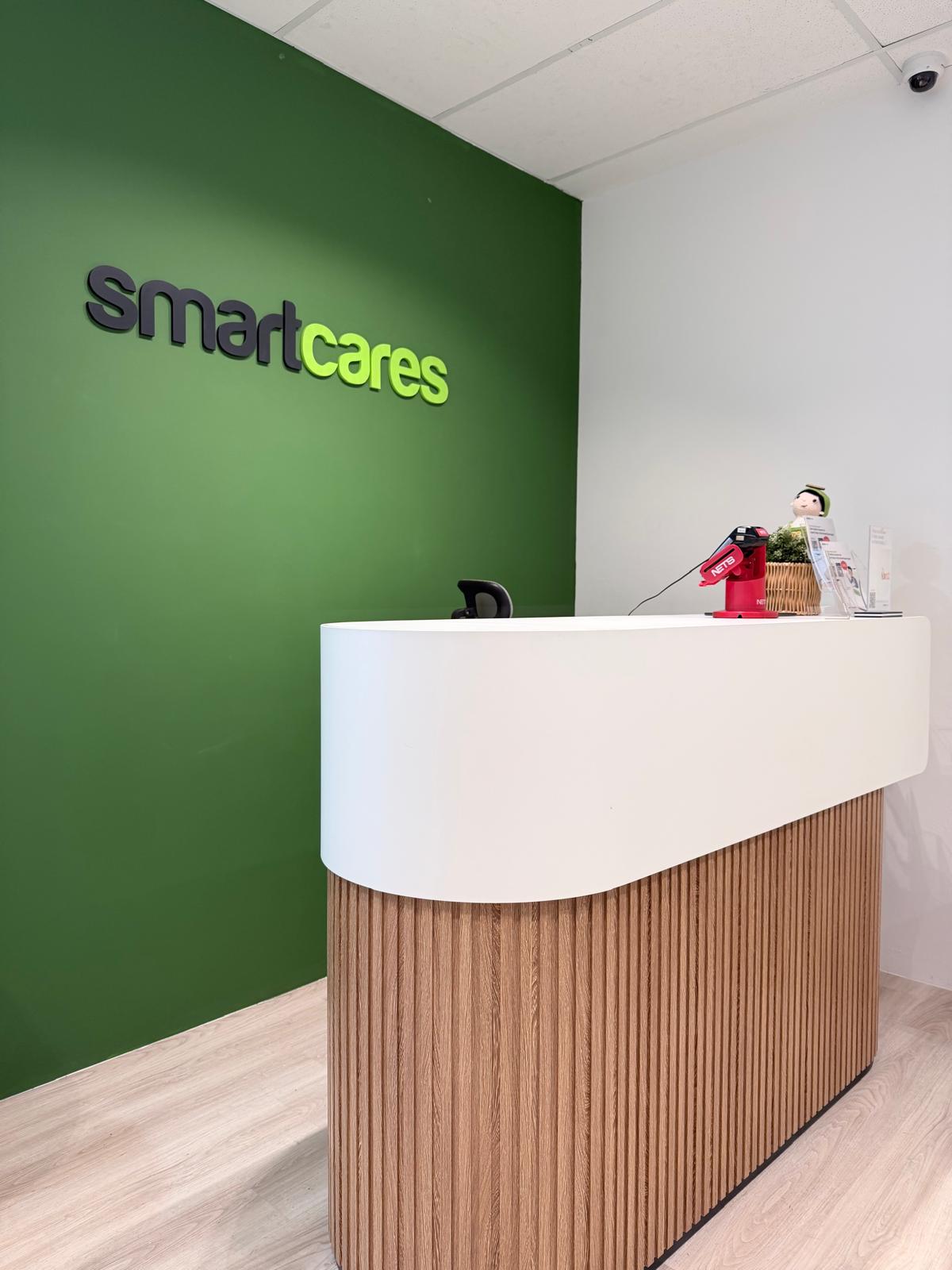 Close-up view of the two-tone white and wood fluted reception counter.