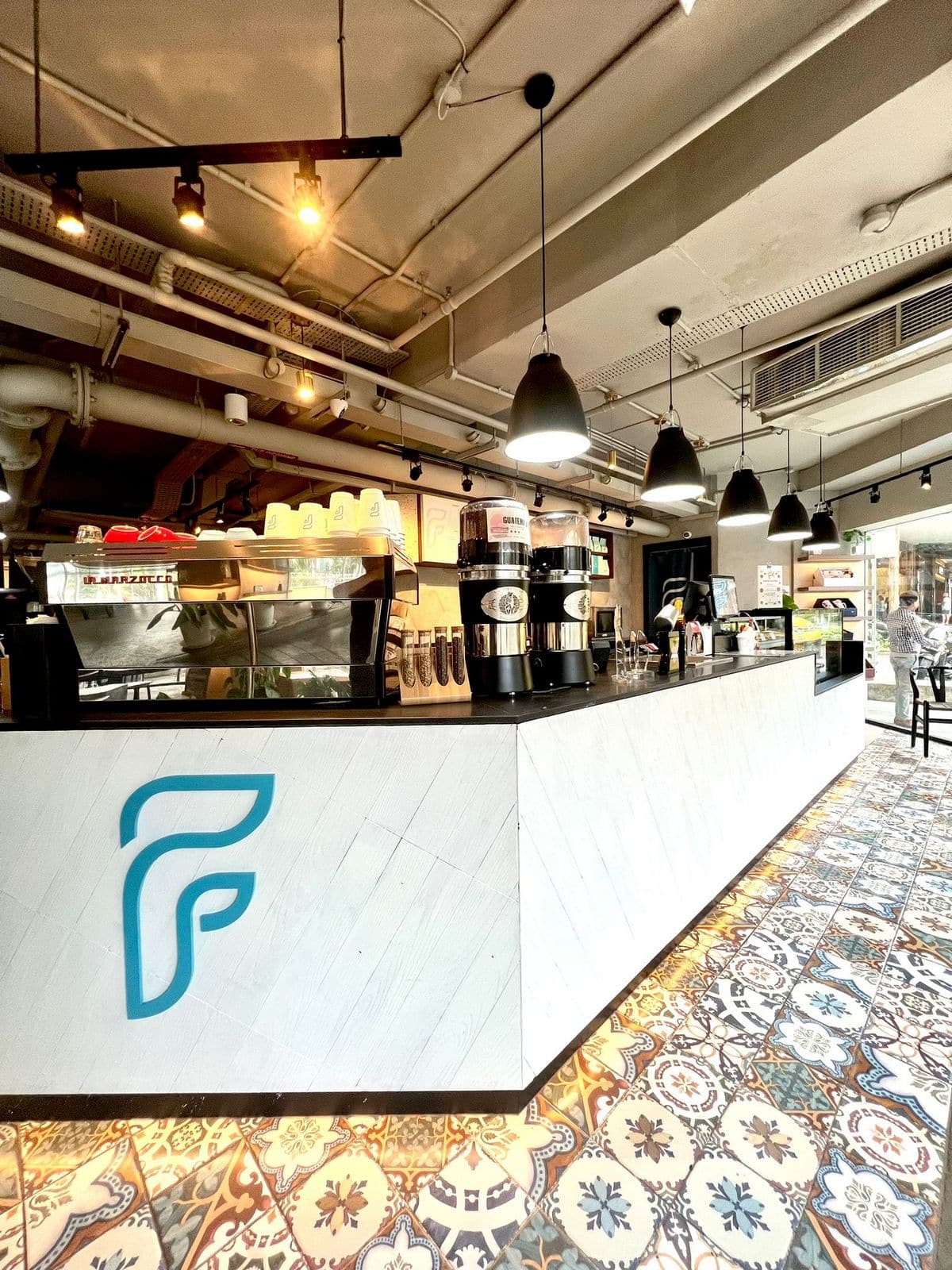 Café counter construction featuring decorative patterned tile flooring built during an F&B renovation in Singapore