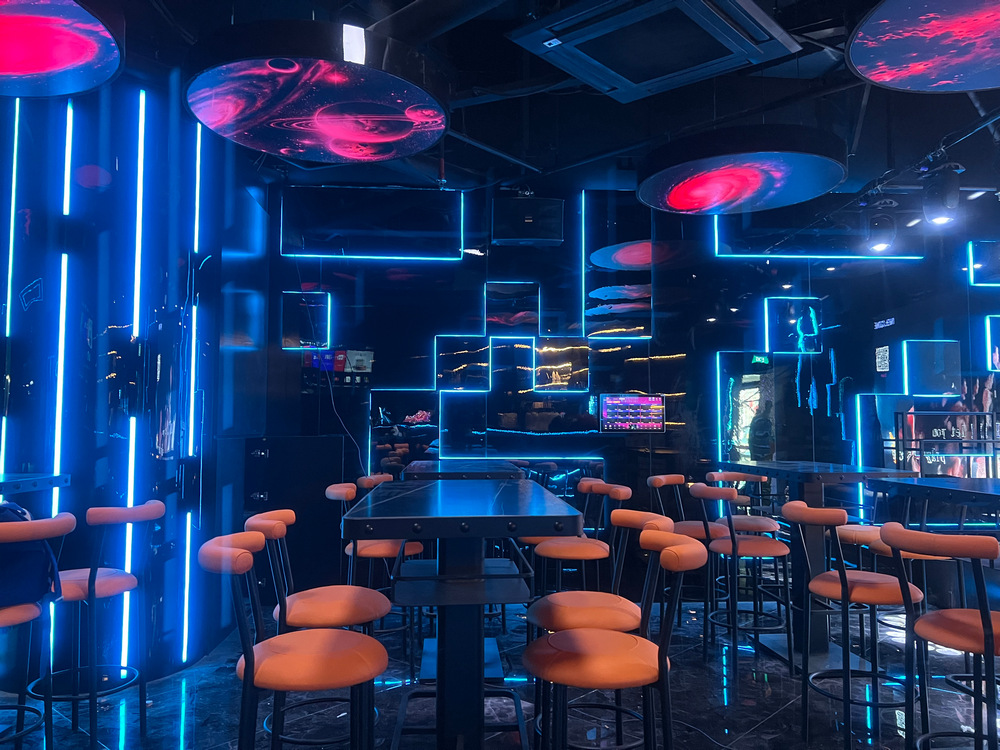 KTV interior with blue LED lighting, ceiling features and seating.