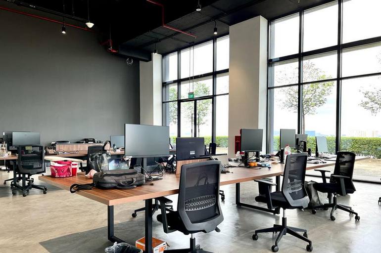 Commercial renovation project featuring modern open-plan office workstations and glass windows in Singapore