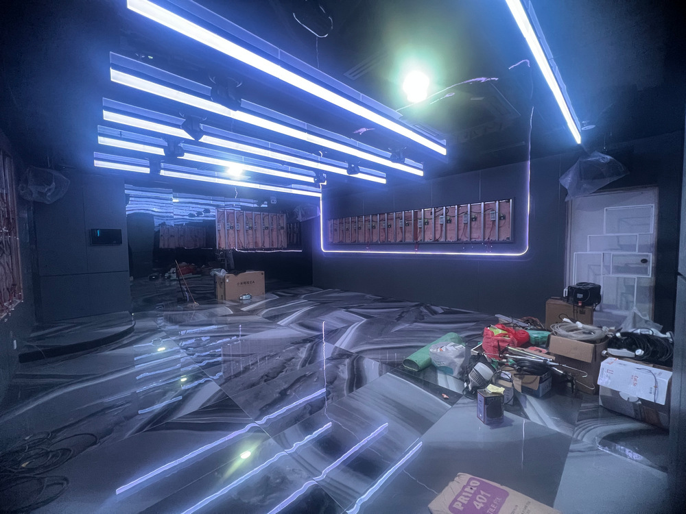 KTV interior showing ceiling lighting and unfinished flooring.